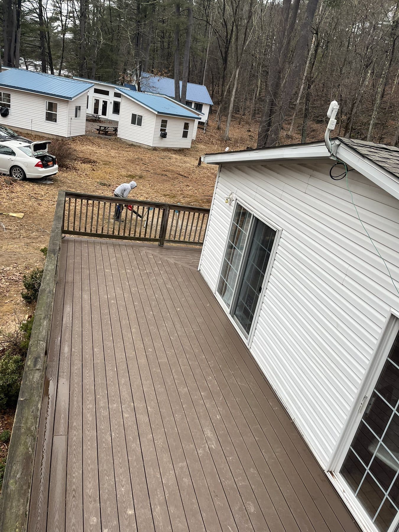 New composite deck with black railings on the same house