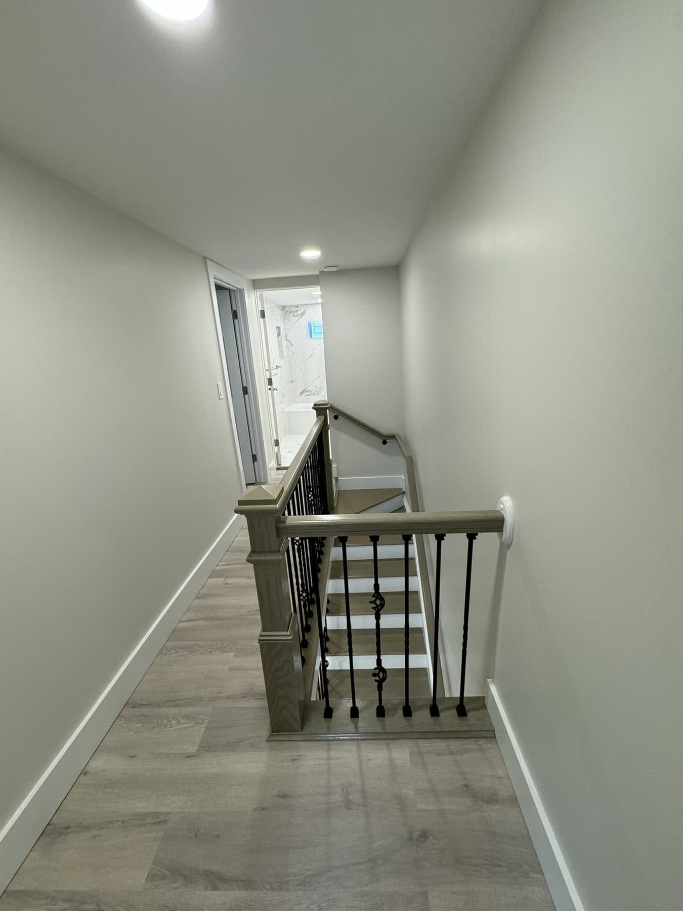 Upstairs landing with new iron railing and LVP flooring
